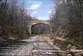 The Sussex County Route 605 bridge over the Cut-Off in Byram, NJ, shown here in 1989, was replaced by a much wider bridge that opened in 2008. The original bridge was retained and now carries a hiking trail.