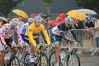 Hushovd (in yellow) at the 2011 Tour de France. Hushovd held the overall lead of the race from the second to the ninth stage of the race. Tour de France 2011 - Lorient - 9535.JPG