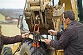 Trench safety - Fastening chains to raise trench box (9247870523).jpg