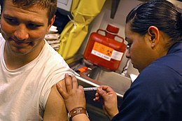 US Navy 070406-N-5627R-326 Airman Sandra Valdovinos, from Delano, Calif., administers Airman Adam Helton, from Mesa, Ariz., a Hepatitis B vaccine.jpg