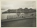 View of Ellis Island buildings and two ferries at pier; appa - (3109321797).jpg