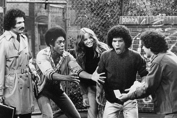 The Sweathogs celebrate a winning lottery ticket as Mr. Kotter looks on.