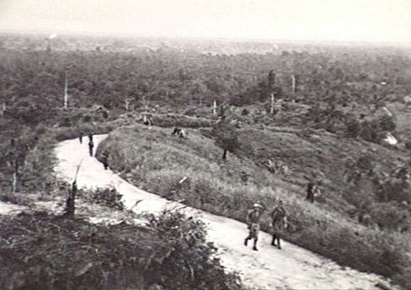 Troops from the 2/13th Battalion patrolling around Miri, August 1945