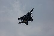 An F-15E Strike Eagle, tail number 91-0302, taking off from RAF Lakenheath in England. The aircraft is assigned to the 492nd Fighter Squadron.