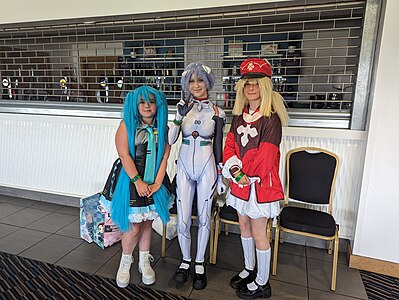 Cosplayers performing as Hatsune Miku (left), Rei Ayanami from Neon Genesis Evangelion (centre), and Klee from Genshin Impact (right). Image: Ash Thawley.