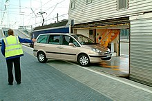Car being driven onto a shuttle carriage at the French terminal in Coquelles Chargement voiture Eurotunnel.jpg