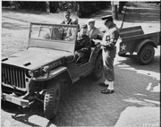 Civilian Photo Technicians (in back of jeep) working for Counter Intelligence Corps, are accounted for by Captain..