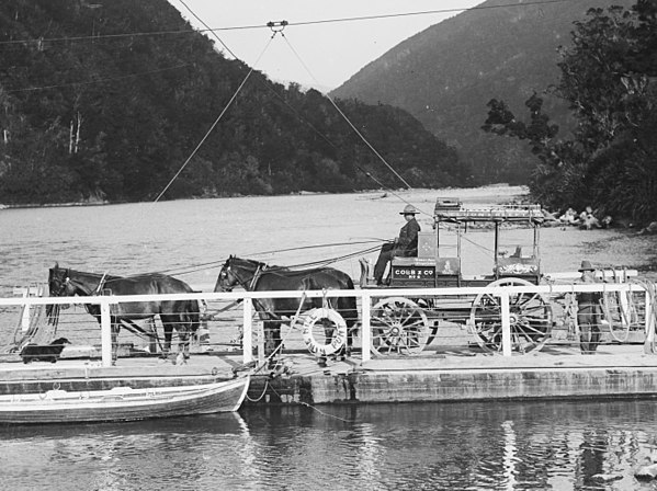 Newman Bros. Nelson-Reefton mail coach crossing the Buller River on the Nine Mile Punt circa 1910 displaying Cobb & Co brand