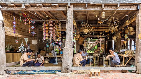 Craftmen at work, bamboo basket weaving and textile mobile sculptures, in Heuan Chan heritage house, Luang Prabang, Laos