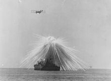 Air burst of a white phosphorus bomb over the USS Alabama during a test exercise conducted by Billy Mitchell, September 1921 Ex-USS Alabama (BB-8) - NH 57483.jpg