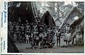 Group of native women and children outside village houses, British New Guinea.jpg
