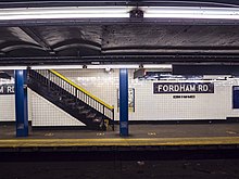 A mosaic and staircase up on the Manhattan-express portion of the southbound platform IND Concourse Fordham Road Mosaic and Stair.jpg