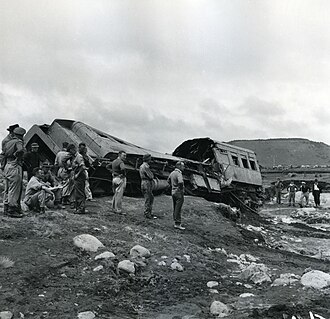 Train wreckage on the banks of the Whangaehu River following the Tangiwai disaster In remembrance of the Tangiwai disaster, 60 years ago on 24 December 1953. (11440593993).jpg