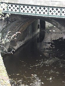 Close-up of the bridge's southern arch, showing some original fabric behind the 1864 and 1909 widenings. Lady's Bridge arch.jpg