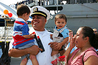 U.S. Navy Lt. Isaias Garcia greets his family during the homecoming celebration for the submarine tender USS Frank Cable (AS 40) in Apra Harbor, Guam