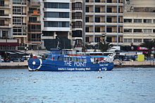 The ferry boat Cominotto with an advert for The Point Shopping Mall.