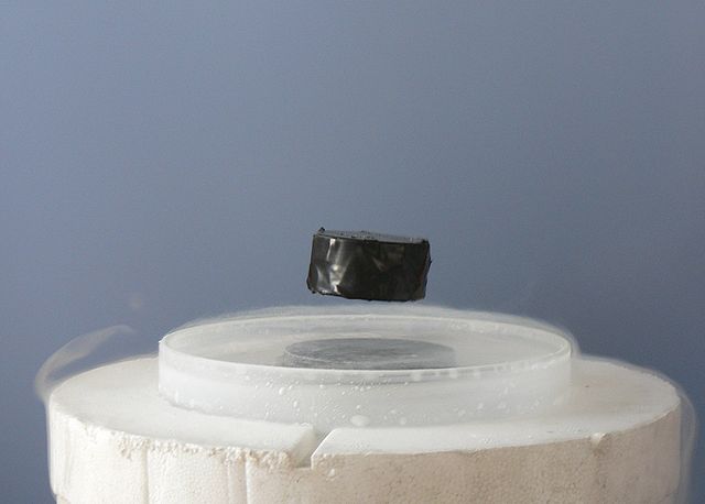 A magnet levitating above a high-temperature superconductor. Today some physicists are working to understand high-temperature superconductivity using 