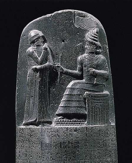 The lunette of the Code of Hammurabi (c. 1750 BC), depicting the king receiving his law from the sun god Shamash