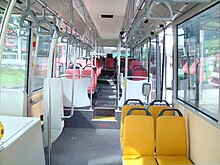 Interior of a wheelchair-accessible transit bus, with bucket seats and smart-card readers at the exit. O500LE-Interior.JPG