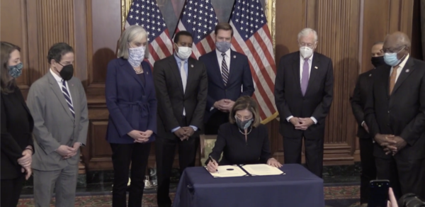 Speaker of the House Nancy Pelosi signing the second impeachment of Trump