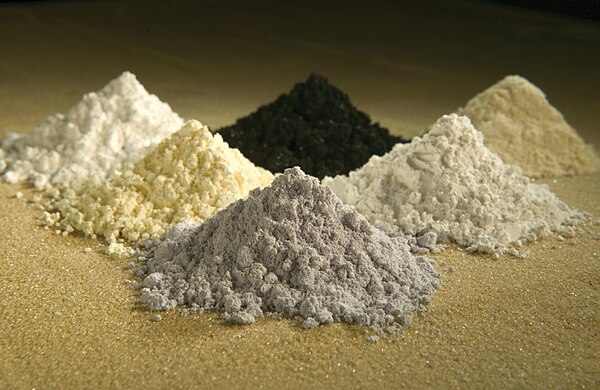 Refined rare-earth oxides are heavy, gritty powders usually brown or black, but can be lighter colors as shown here.Legend: gadolinium · praseodymium 