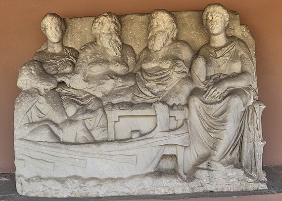Relief from grave of Lysimachides (320 BC) Two men and one woman sit together as Charon, the ferryman of the Underworld, approaches to take him to the land of the dead.