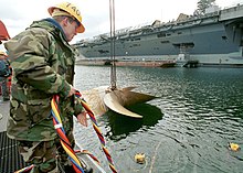 US Navy tender with umbilical - A typical surface supplied diving situation US Navy 020419-N-9421C-002 Aircraft carrier screw removed for overhaul.jpg
