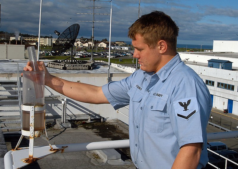 File:US Navy 070327-N-6247M-015 Aerographer's Mate 3rd Class Timothy Fleming checks the rain meter during an hourly weather observation, meteorological aviation observation report.jpg