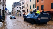 A police vehicle patrols a flooded street in Vicenza, Italy in 2010