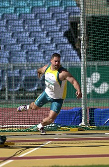 Short throwing the discus during discus F12 competition at the 2000 Summer Paralympics. Short won gold in this event. 291000 - Athletics field discus F12 Russell Short gold action 3 - 3b - 2000 Sydney event photo.jpg