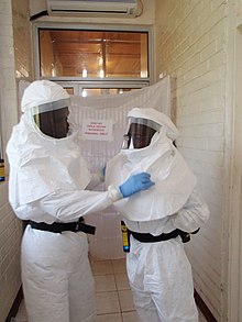 Liberian laboratory technicians in personal protective equipment preparing to test Lassa fever samples. 454277-Q-GYI14-255(1).jpg