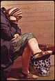 AN OLD LADY RESTS SORE FEET AND SWOLLEN LEGS ON A BENCH IN NICOLLET MALL - NARA - 551439.jpg