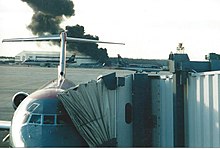 Smoke rising from a warehouse seconds after the crash of Air Midwest Flight 5481.