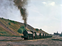 A National Coal Board Hunslet Austerity 0-6-0ST No 63.000.326 (works number 3776 of 1952) hauls ten loaded "Merry-go-round" coal hopper wagons from Bickershaw Colliery to the exchange sidings, 18 August 1983 Austerity at Bickershaw Colliery 02.jpg