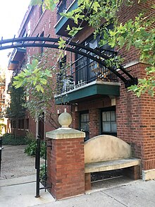 Bench outside apartment courtyard (38658029362).jpg