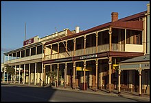 Corrugated-iron balconies and awnings are a characteristic feature of Broken Hill's architecture and streetscape Broken Hill The Workers Club early morning (21363443458).jpg