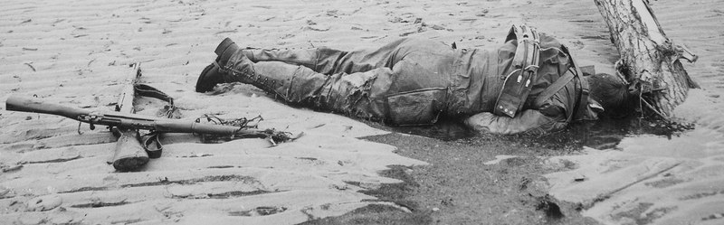 File:Crossed rifles in the sand are a comrade's tribute to this American soldier who sprang ashore from a landing barge... - NARA - 513175 (cropped).tif