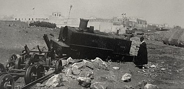 A man inspects the derailed Decauville locomotive at the scene of the attack that served as the pretext for the French bombardment of Casablanca in 1907.[24][25]