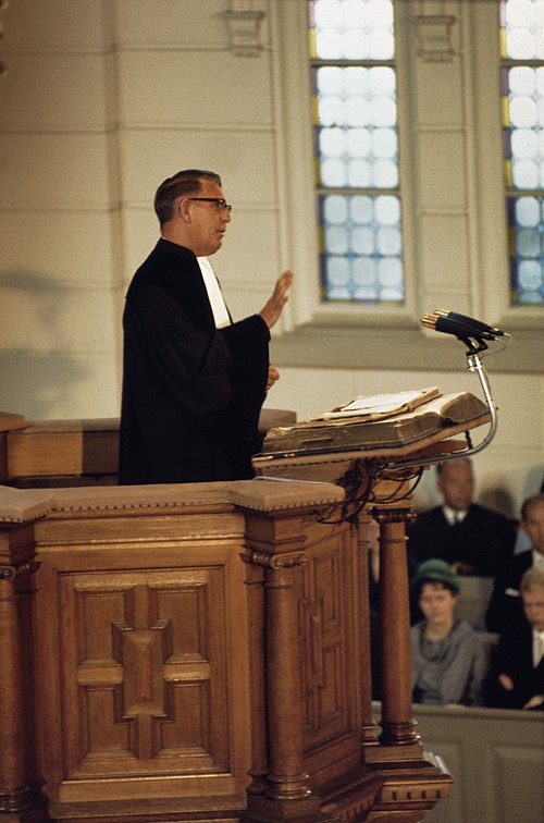 A Reformed Christian minister preaching from a pulpit, 1968