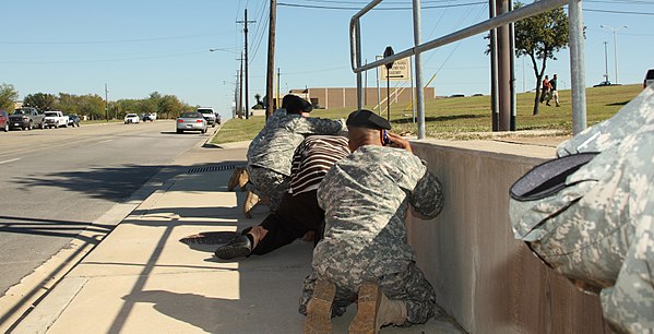 Bystanders take cover as shots ring out from the Soldier Readiness Processing Center.