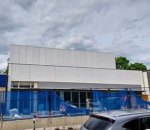 Photo of a subway station entrance under construction which appears largely completed.