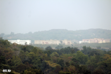 View of GCE Keonjhar surrounded by mountains in winter.