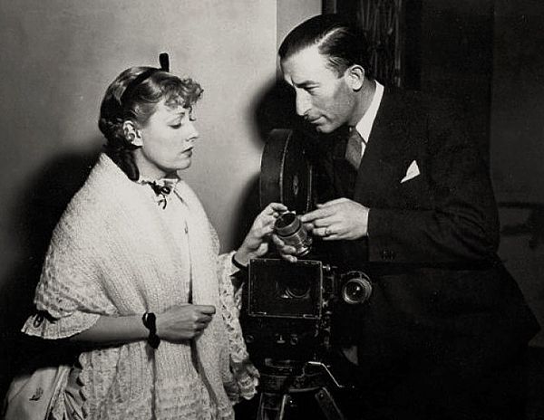 Irene Dunne and John J. Mescall (cinematographer) on the set of Show Boat (1936) - publicity still