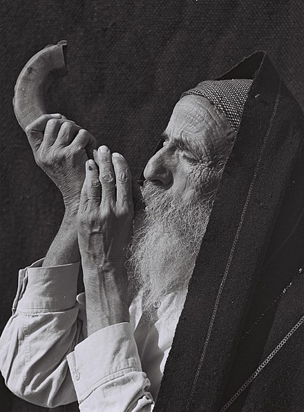 Jewish elder blowing the ram's horn (shofar)