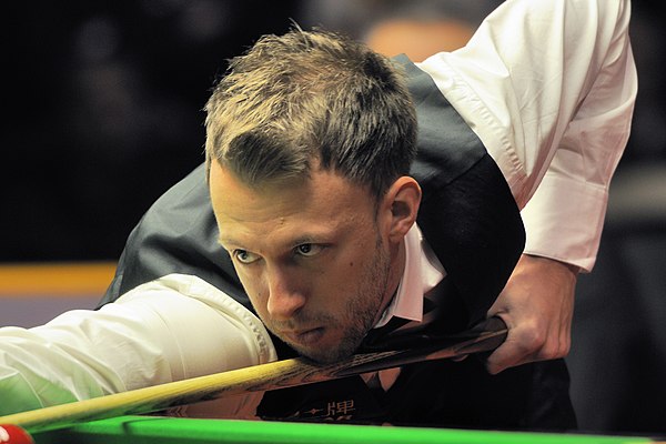 The defending champion Judd Trump (pictured) was beaten 6–3 by Stephen Maguire in the last-32.