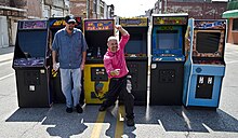 Mark Hoff outside the original Twin Galaxies arcade location in Ottumwa, Iowa in 2014 Mark Hoff and Joel West.jpg