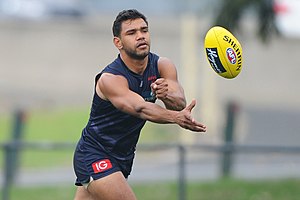 Neville Jetta handballing with his left. Australian rules players use opposite fists to pass to the left or right. Neville Jetta handballing.2.jpg