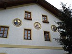 East  Gable facade with 3 mosaic medallions on the old school