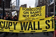 Occupy Wall Street protest in New York City: "Foreclose On Banks Not People" Occupy Wall Street March 2012 foreclosure banner.jpg