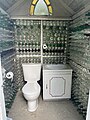 Functional washroom with walls made of glass bottles